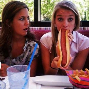 2 Girls eating hotdogs