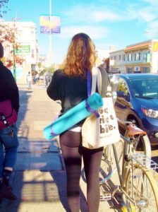Woman carrying yoga mat