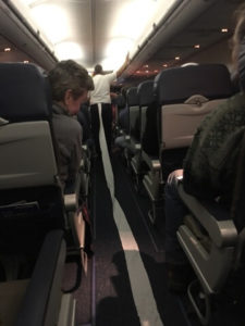 Man with toilet paper still attached to his pants during a flight