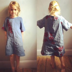A little girl wearing full length linen skirt