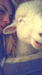 A woman and sheep laughing