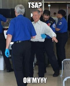 elderly asian man getting screened at airport by TSA