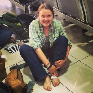 Woman cleaning her foot with wet wipes at an airport