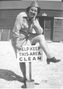 Female US Army personnel in front of a board sign