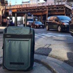 a roller suitcase on a road