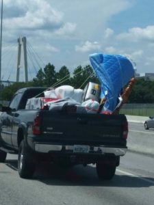Big mattress almost falling out while being transported on a pickup van