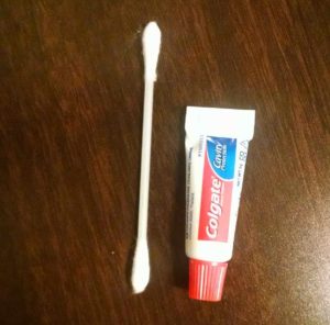 Colgate travel toothpaste against earbuds