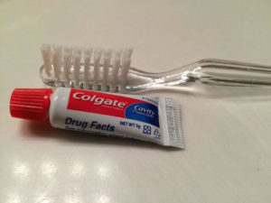 Travel sized toothpaste against toothbrush